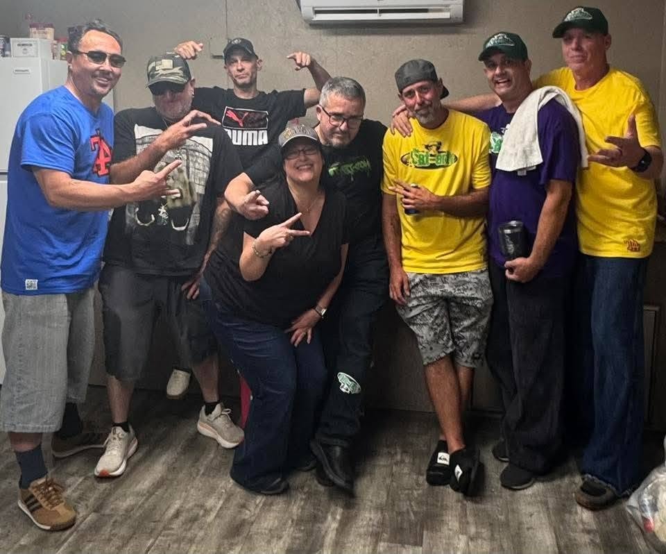 Eight people including DJ Natural Nate® and Michaela Foley gathered indoors at the Florida underground show May 2026