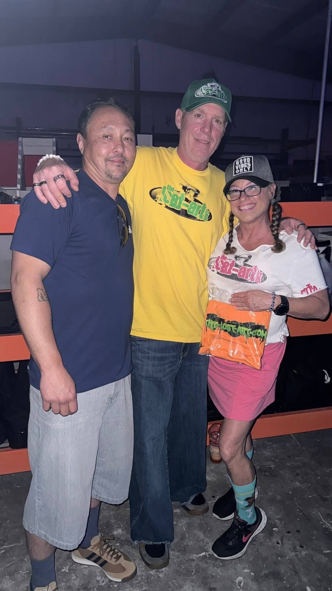 DJ Natural Nate® in The-Lost-Art.com yellow shirt with two friends at the Florida show venue May 2026