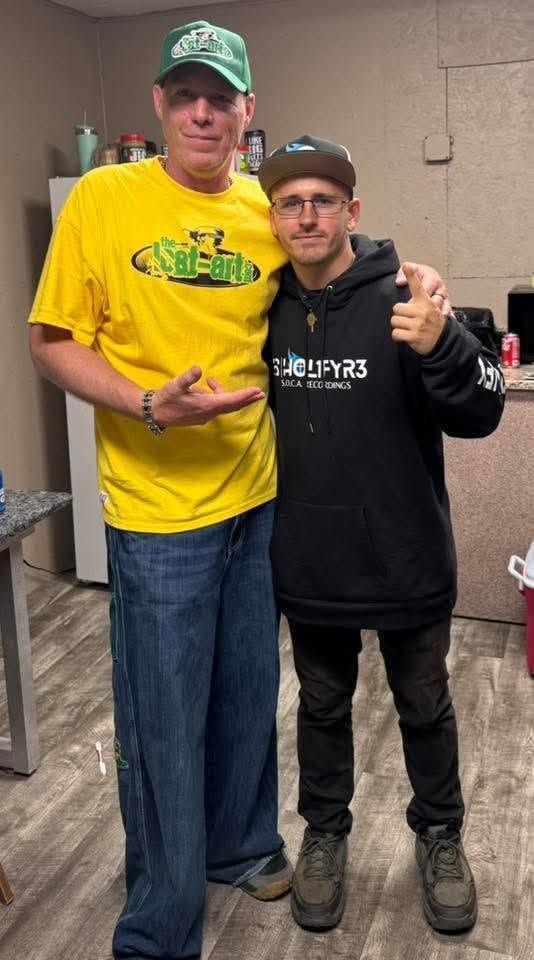 DJ Natural Nate® in The-Lost-Art.com yellow shirt with DJ HOL1FYR3 in S.O.C.A. Recordings hoodie at the Florida show May 2026