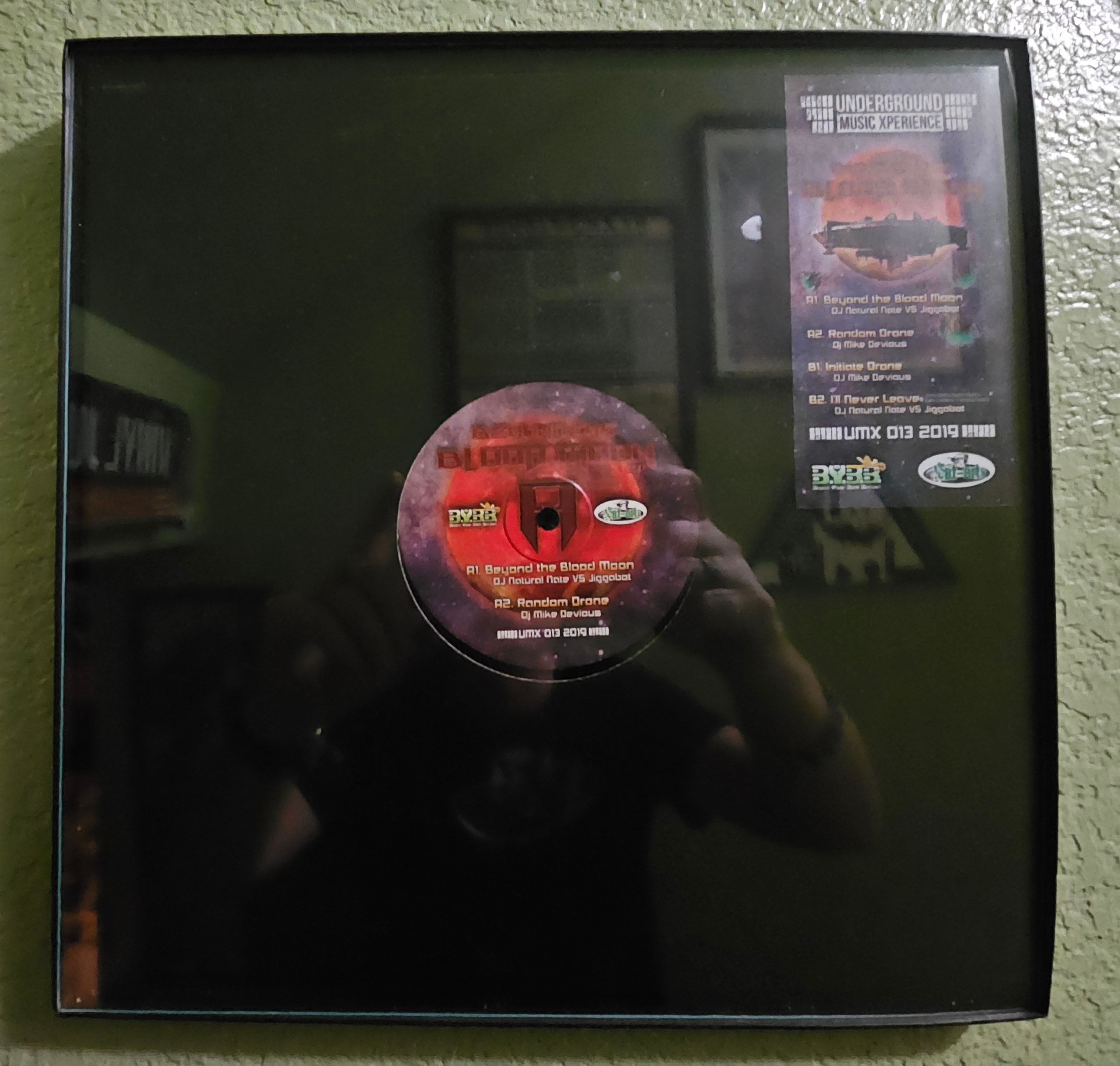 Under The Blood Moon EP, UMX 013, framed original vinyl A-side label, Beyond The Blood Moon, DJ Natural Nate VS Jiggabot, BYBB and UMX logos, DJ Natural Nate Wall of Fame