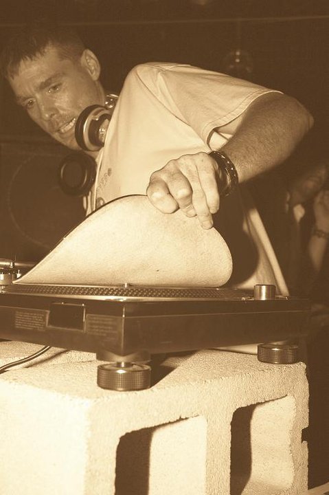 DJ Natural Nate® at the turntables, hands on vinyl